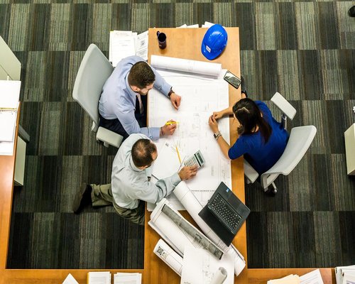 Experienced service team checking apartment plan in Dhaka neighborhood